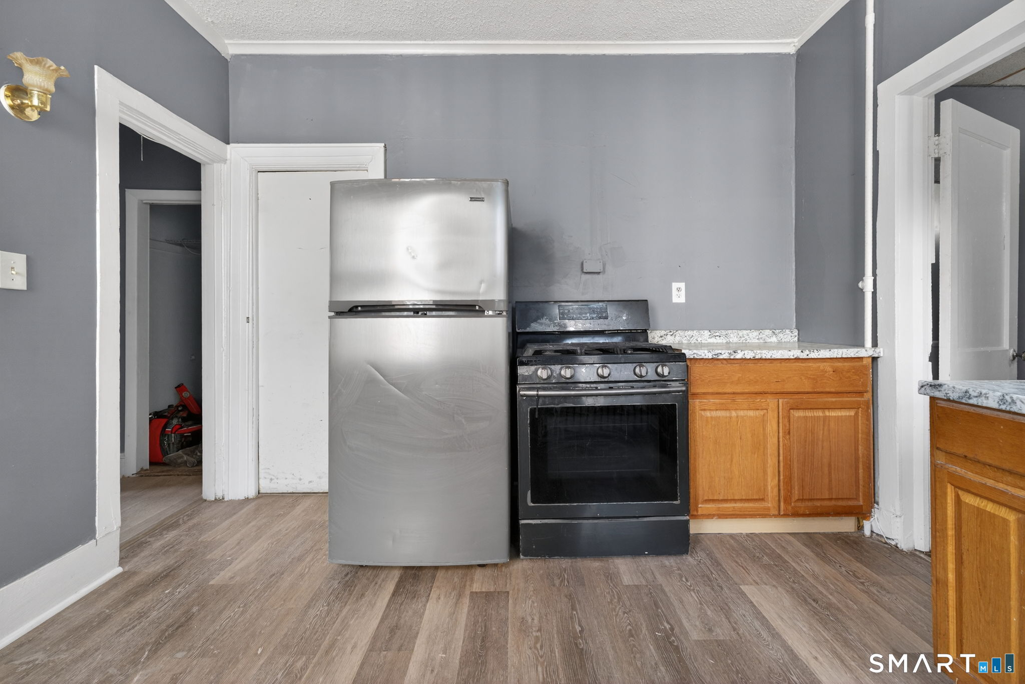 187 Whitney Street, Unit A2 Hartford, CT 06105 - Photo 13 of 17 a kitchen with a refrigerator and a stove top oven