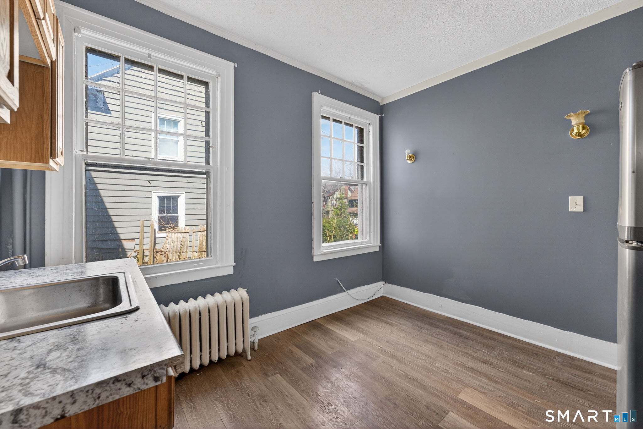 187 Whitney Street, Unit A2 Hartford, CT 06105 - Photo 14 of 17 a view of an empty room with wooden floor and a window