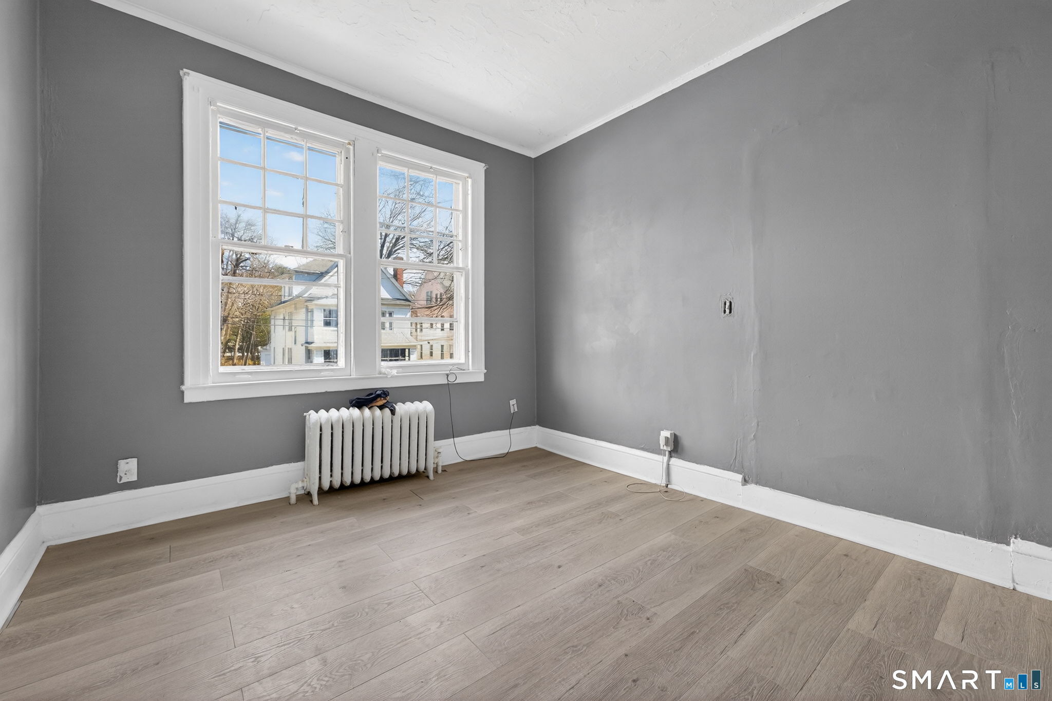 187 Whitney Street, Unit A2 Hartford, CT 06105 - Photo 6 of 17 an empty room with windows