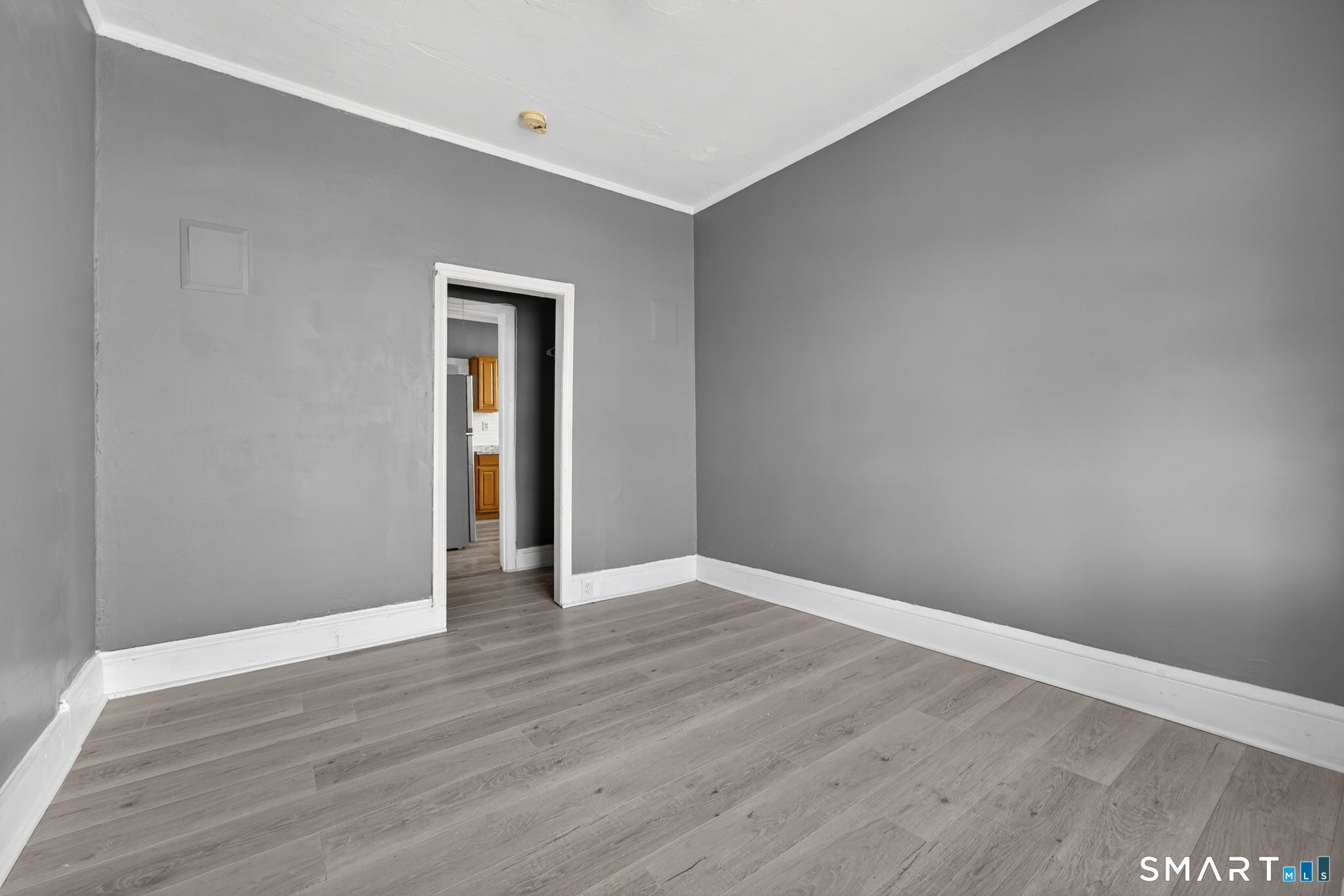 187 Whitney Street, Unit A2 Hartford, CT 06105 - Photo 7 of 17 a view of an empty room with wooden floor