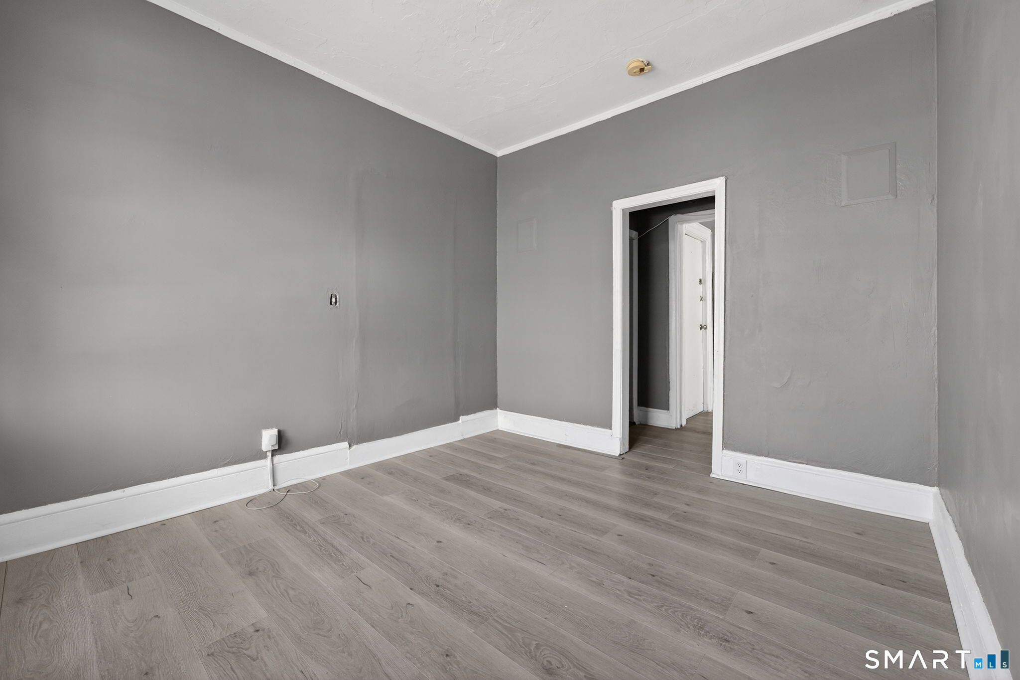 187 Whitney Street, Unit A2 Hartford, CT 06105 - Photo 8 of 17 a view of an empty room with wooden floor