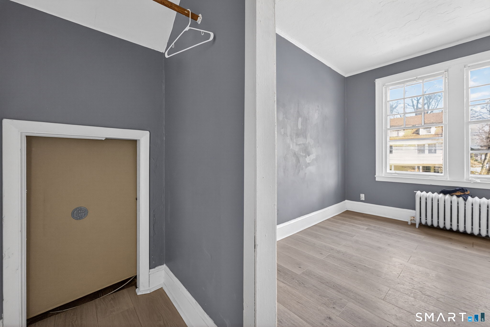 187 Whitney Street, Unit A2 Hartford, CT 06105 - Photo 9 of 17 a view of an empty room with wooden floor and a window