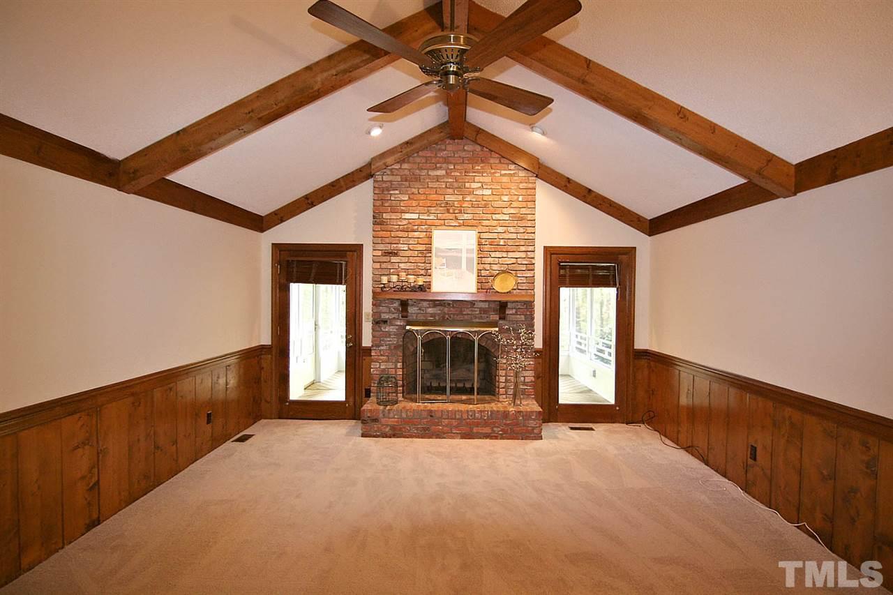 2816 Mattlyn Court Raleigh, NC 27613 - Photo 6 of 25 Xtra Large Living Room offers Lots of Space to Enjoy Life. Notice the Beautiful Brick Fireplace with Raised Hearth, Vaulted Ceiling with Beams -- Brand New Paint and Carpet.