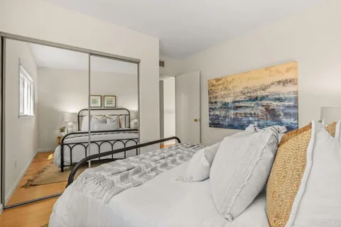 a bedroom with a large bed and a large window