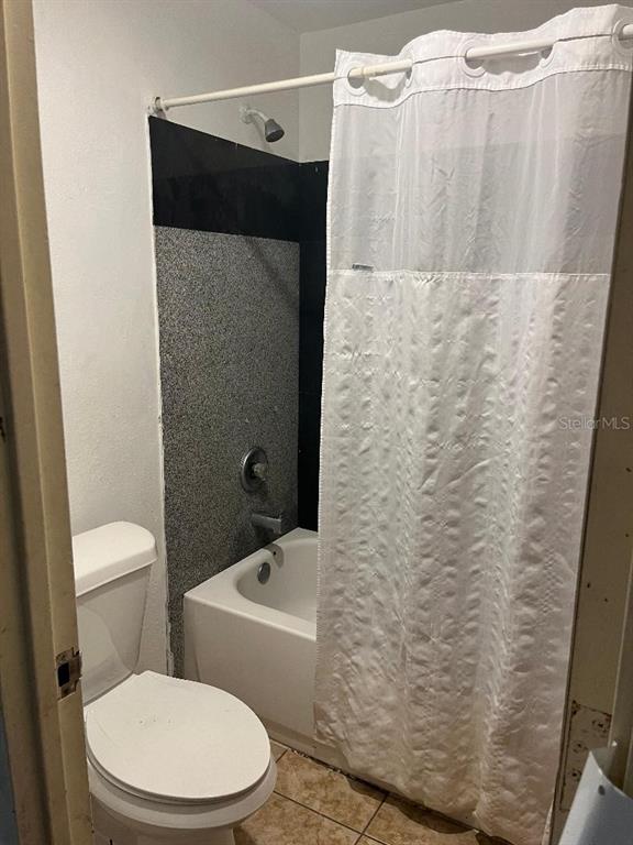 8421 South Orange Blossom Trail, Unit 254 Orlando, FL 32809 - Photo 13 of 13 a bathroom with a toilet and a shower curtain