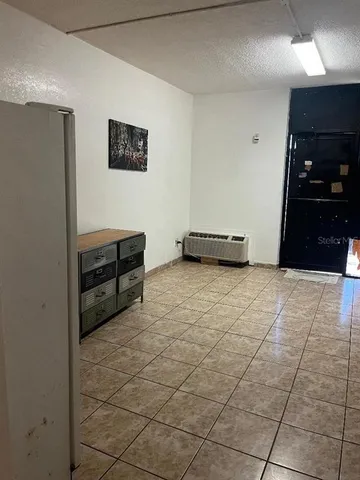 a room with a bench and cabinets