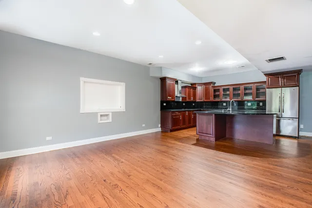 a view of kitchen with cabinets and wooden floor