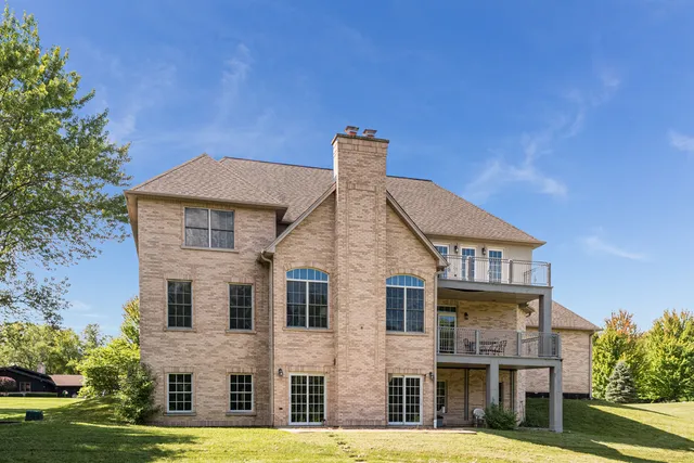 a view of a big house with a yard