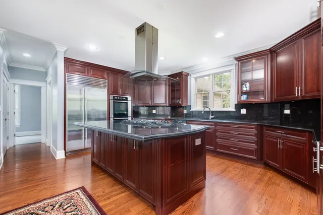 a kitchen with stainless steel appliances granite countertop a stove a sink and a refrigerator