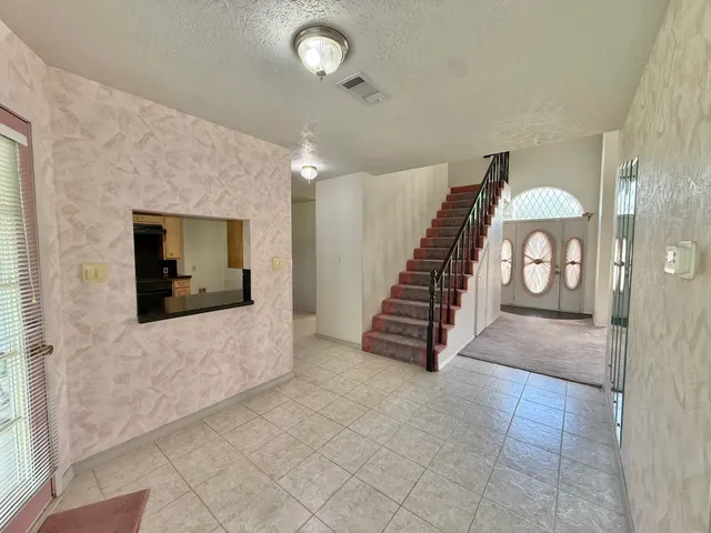 a view of an entryway with wooden floor and a livingroom view