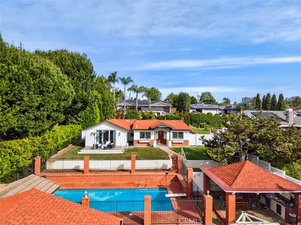 an aerial view of multiple houses with a yard