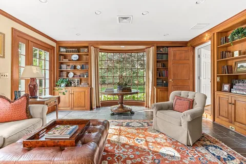 a living room with furniture and a floor to ceiling window