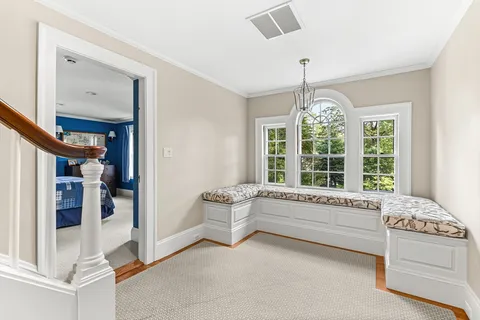 a spacious en suite bathroom with a large tub and window