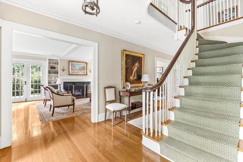 a view of entryway livingroom and hall with wooden floor
