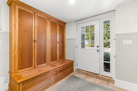 a view of a house with a big yard and large tree