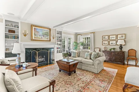 a living room with furniture a fireplace and a table