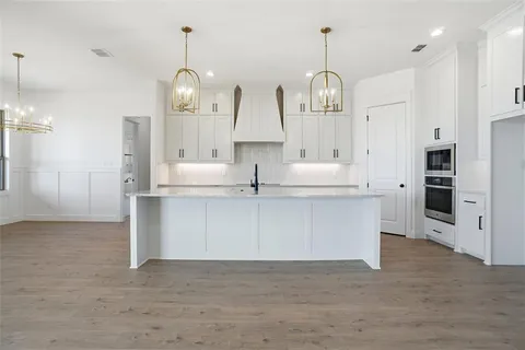 a view of kitchen with granite countertop cabinets and stainless steel appliances