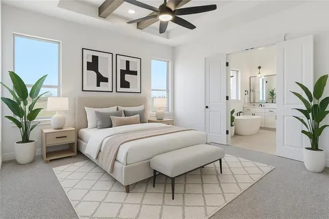 a spacious bedroom with a bed and a potted plant