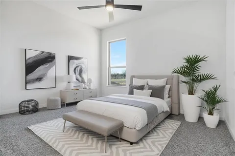 a bedroom with a bed and potted plant