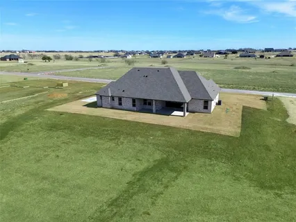 a aerial view of a house with a garden and lake view