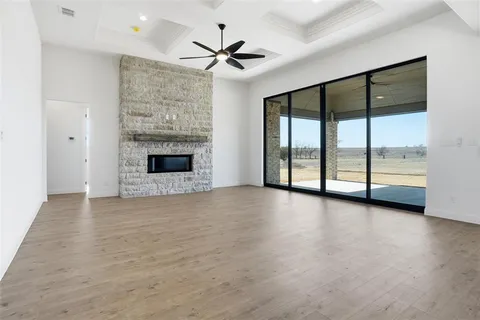 an empty room with fireplace and windows