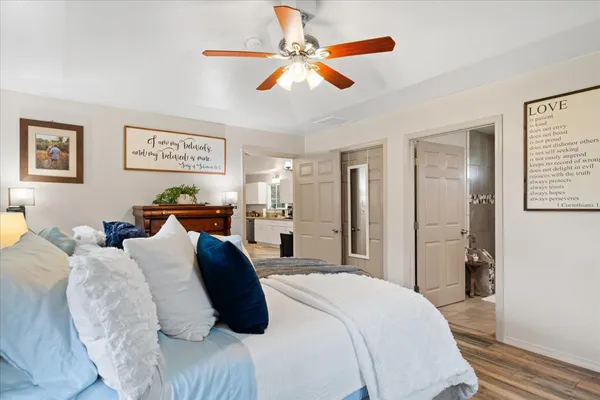 a bedroom with a bed and a chandelier