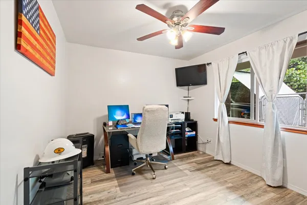 a view of a workspace with furniture and a window