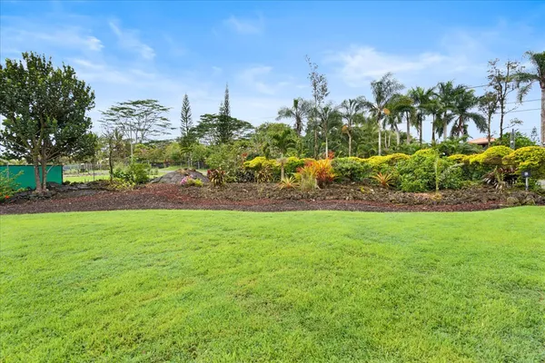 a view of a garden with a building in the background