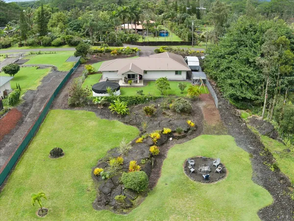 an aerial view of a garden with swimming pool