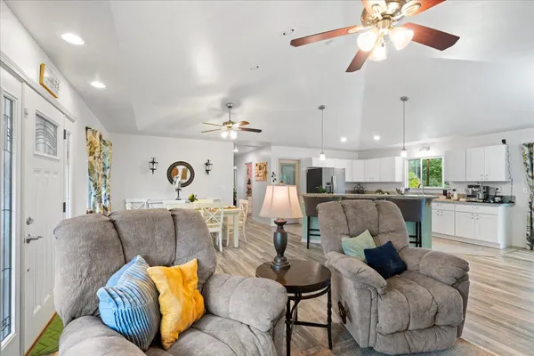 a living room with furniture and kitchen view