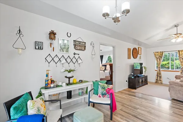 a living room with furniture flowerpot and window