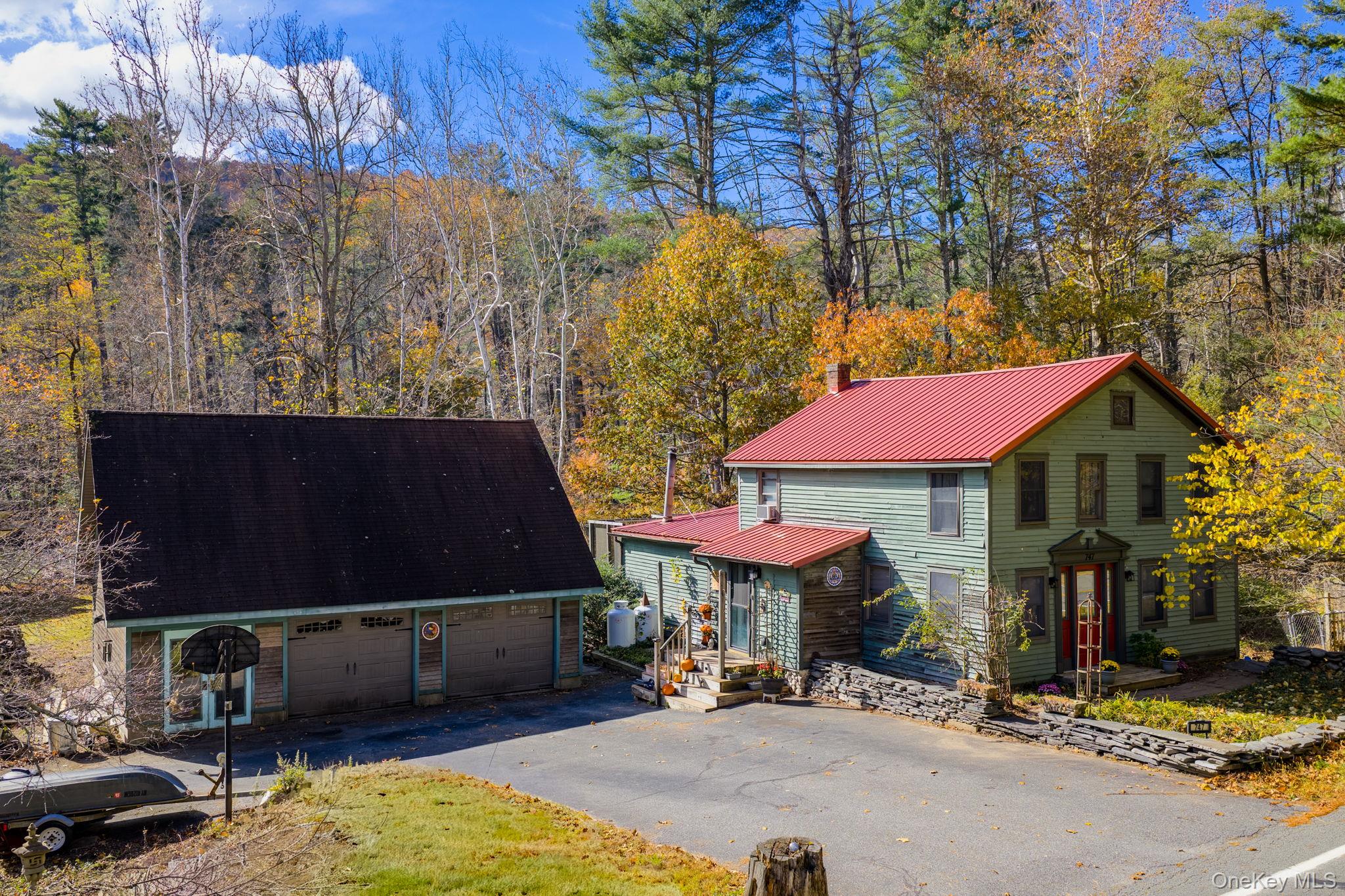 747 Oakland Valley Road Cuddebackville, NY 12729 - Photo 1 of 1 a view of patio with a table and chairs under an umbrella