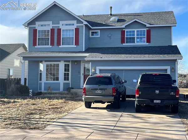 a view of a house with car parked