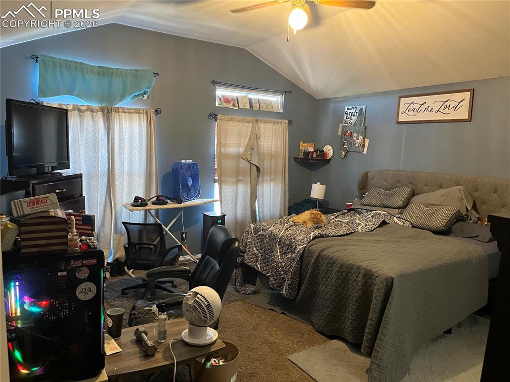 7860 Gladwater Road Peyton, CO 80831 - Photo 14 of 22 a bedroom with a bed and a flat screen tv