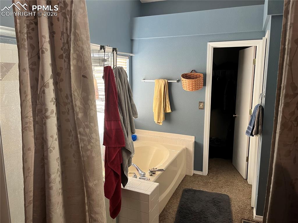 7860 Gladwater Road Peyton, CO 80831 - Photo 15 of 22 a view of walk in closet with clothes and shoes