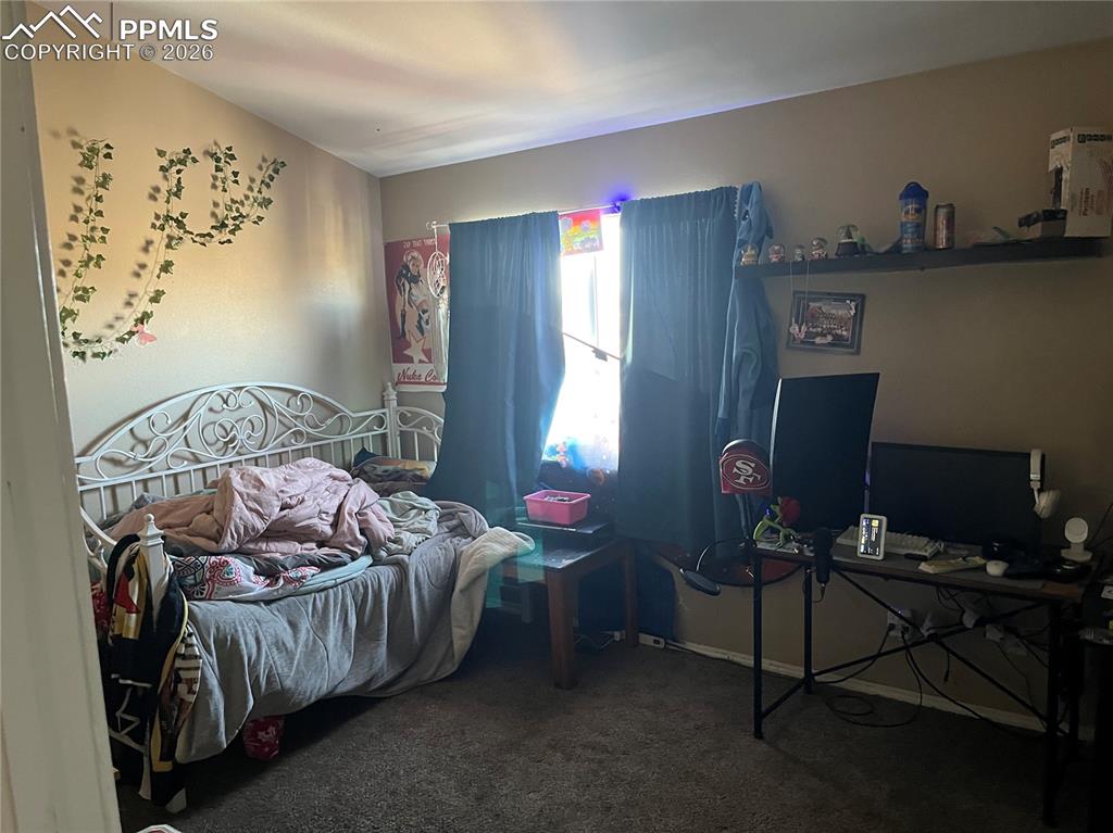 7860 Gladwater Road Peyton, CO 80831 - Photo 16 of 22 a bedroom with a bed and a window