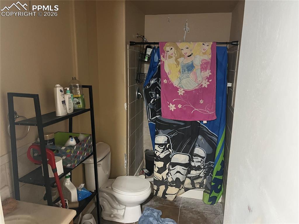 7860 Gladwater Road Peyton, CO 80831 - Photo 20 of 22 a bathroom with a toilet sink and mirror