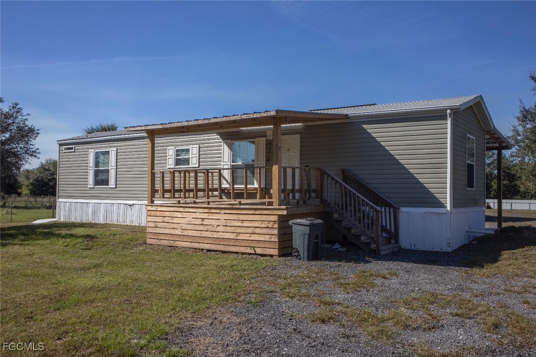 720 North Estribo Street Clewiston, FL 33440 - Photo 1 of 39 a front view of a house with a garden