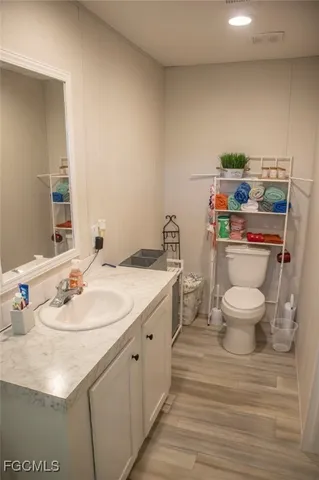 a bathroom with a sink toilet and a mirror
