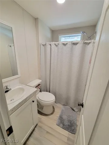 a bathroom with a toilet a sink and a shower