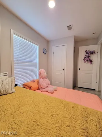 a large bedroom with a bed and a window