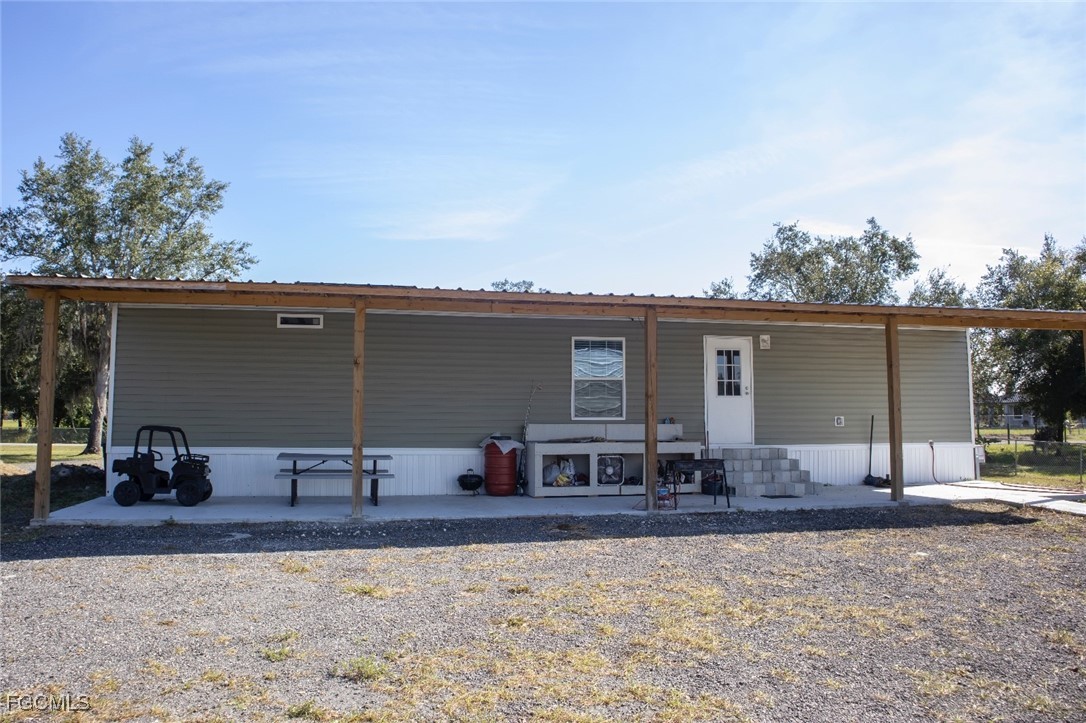 720 North Estribo Street Clewiston, FL 33440 - Photo 16 of 39 a backyard of a house with table and chairs