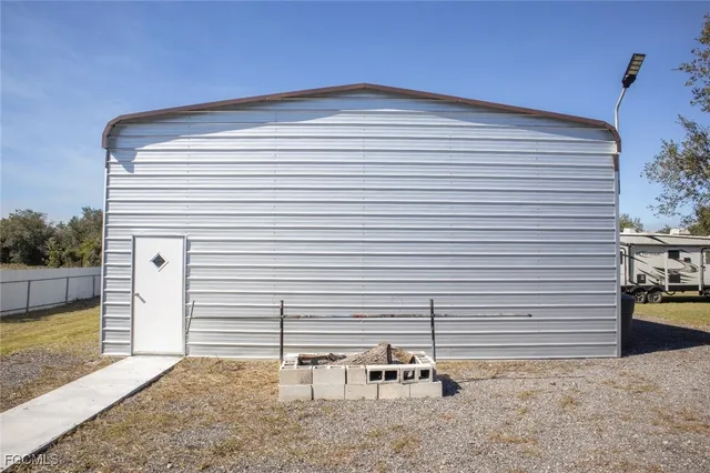 a backyard of a house with table and chairs