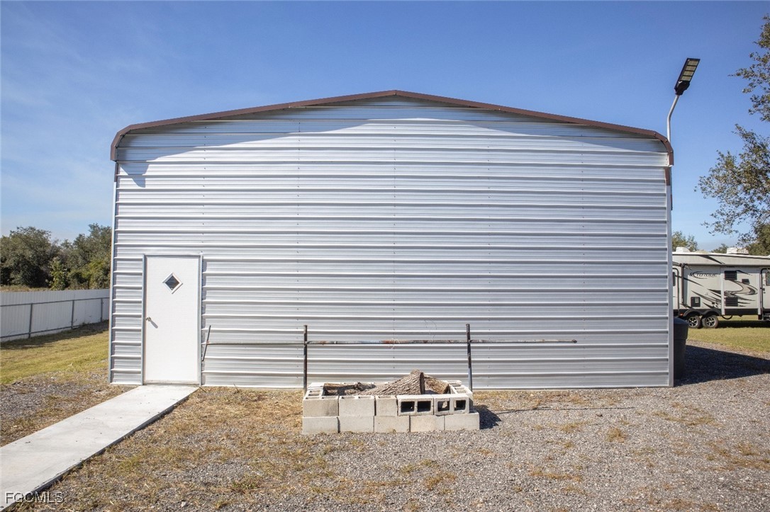 720 North Estribo Street Clewiston, FL 33440 - Photo 17 of 39 a backyard of a house with table and chairs
