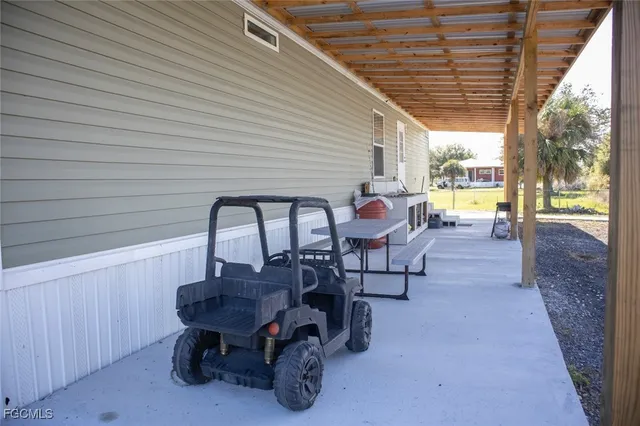 a view of a patio with table and chairs and couches with wooden roof and stairs