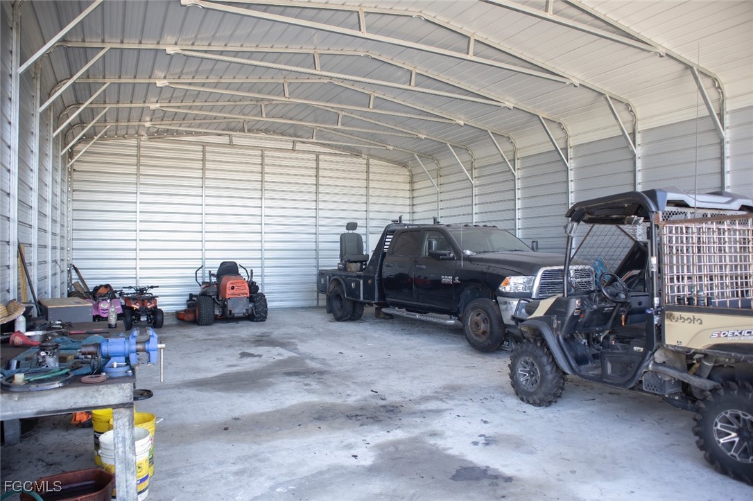 720 North Estribo Street Clewiston, FL 33440 - Photo 20 of 39 a view of a garage with parked cars