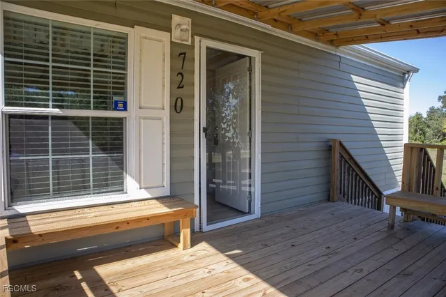 a view of balcony with wooden floor and fence