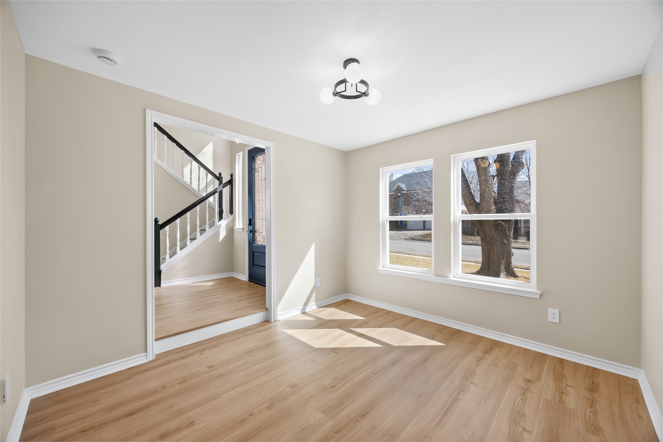 1002 Crestview Street Round Rock, TX 78681 - Photo 18 of 40 Spare room featuring stairs and light wood-style floors