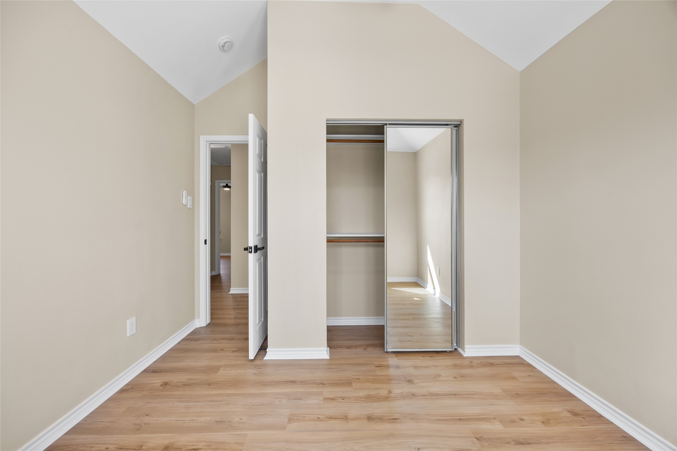 1002 Crestview Street Round Rock, TX 78681 - Photo 32 of 40 Unfurnished bedroom featuring light wood-style floors, a closet, and vaulted ceiling
