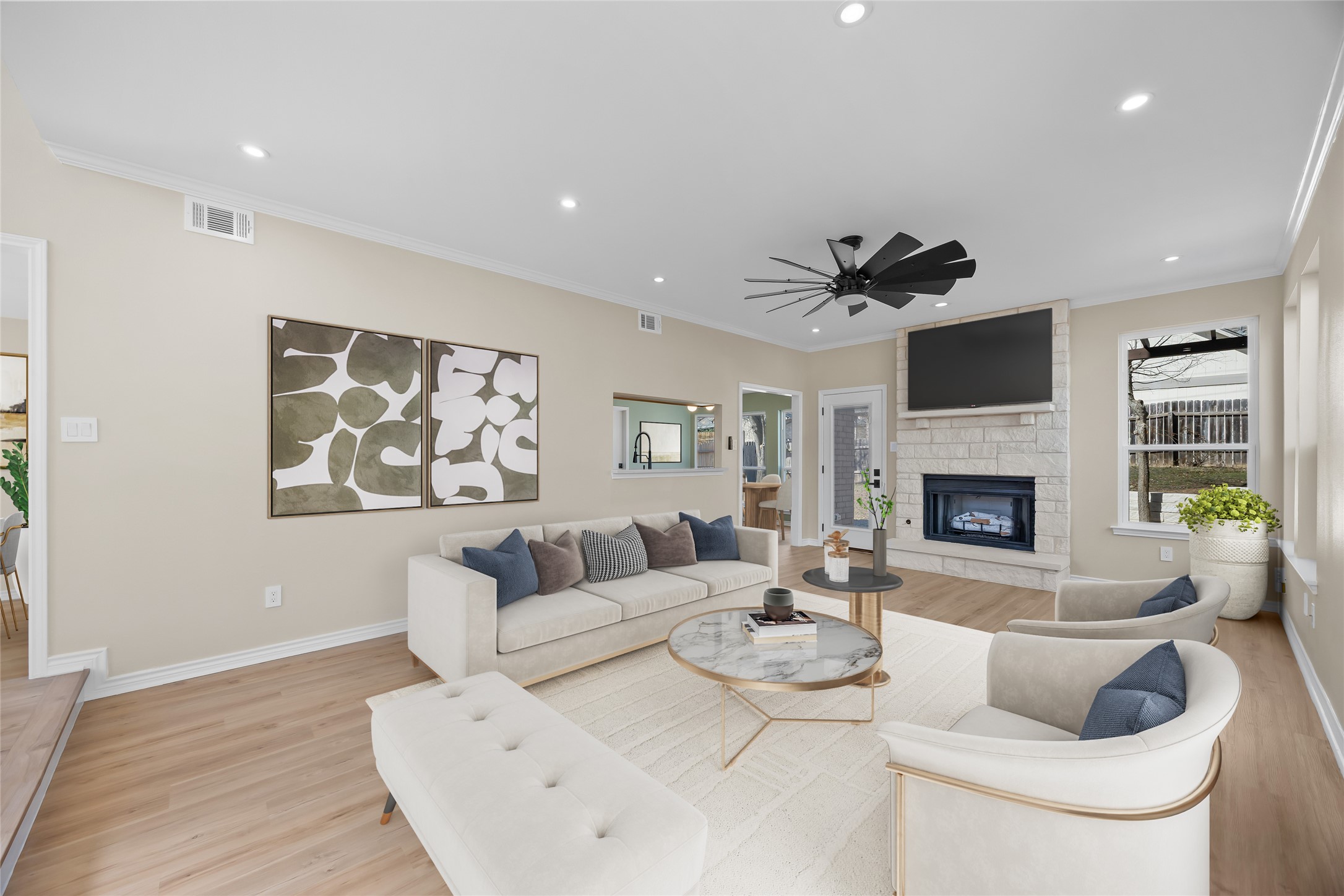 1002 Crestview Street Round Rock, TX 78681 - Photo 8 of 40 Living area featuring light wood-type flooring, a stone fireplace, a ceiling fan, crown molding, and recessed lighting